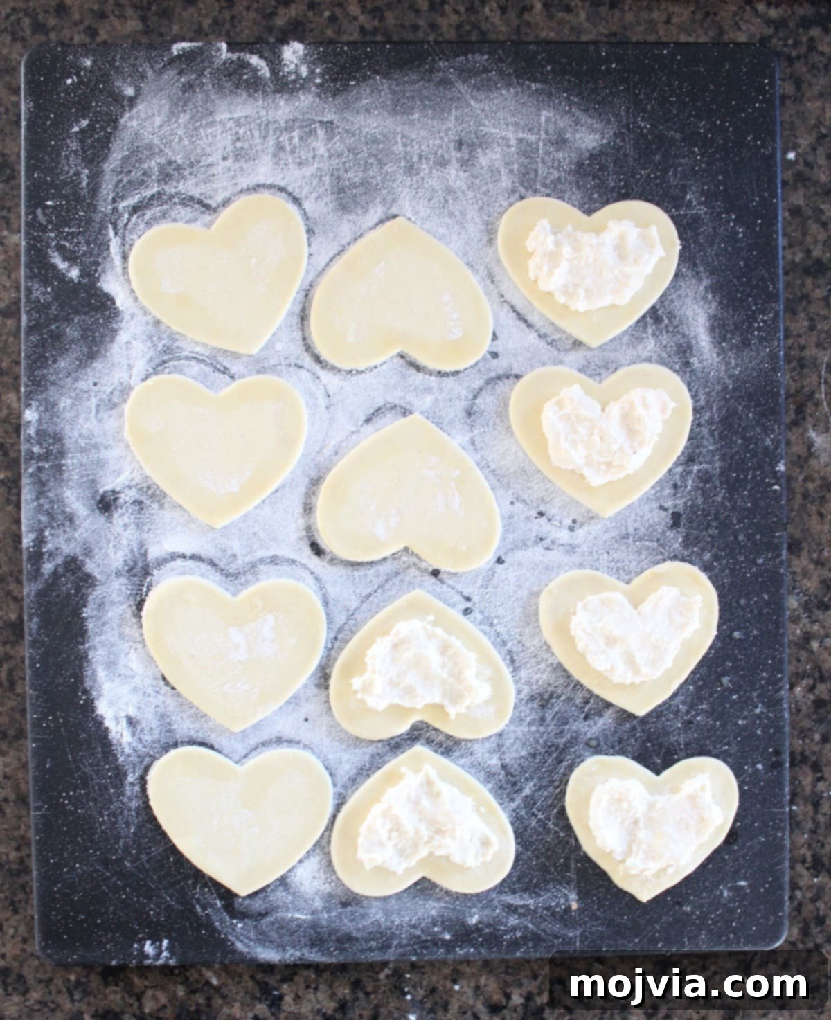 Strawberry Cheesecake Puff Pastry Hearts 9 Adding cream cheese filling to puff pastry hearts