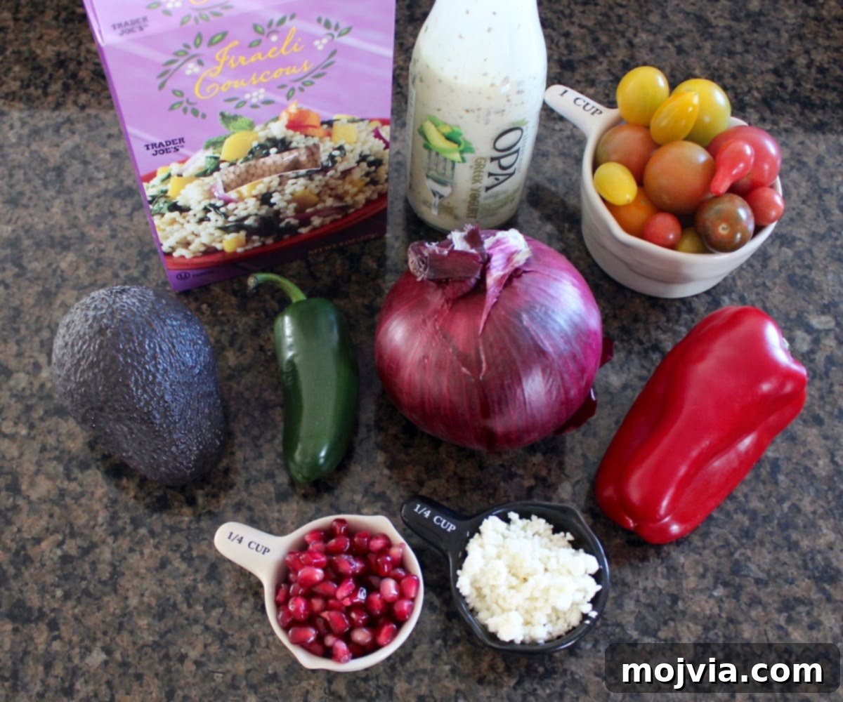 Creamy Avocado Pearl Couscous Salad 3 A collection of fresh ingredients for couscous avocado salad arranged on a granite countertop