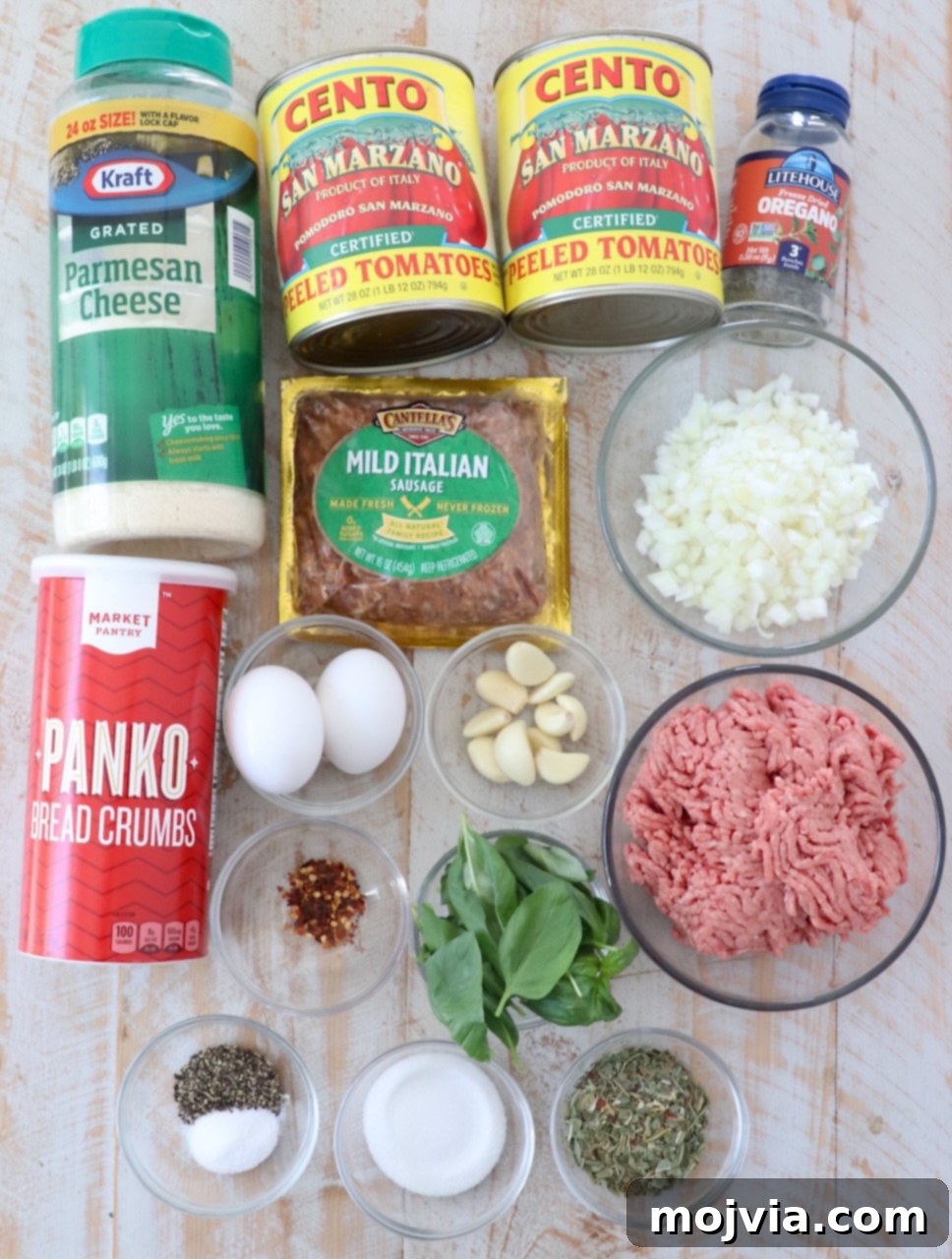 Set-and-Forget Slow Cooker Meatballs and Marinara 3 ingredients for slow cooker meatballs and marinara sauce on white wood board