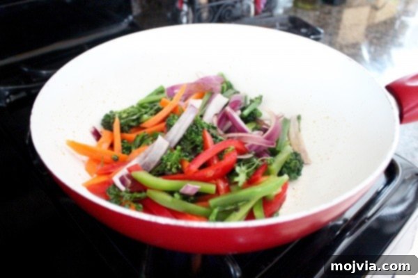 Vibrant Thai Peanut Pineapple Bowl 7 First step of sautéing carrots, onions, bell peppers, and broccoli