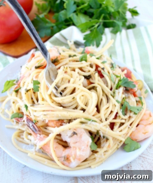 Creamy One Pot Tuscan Shrimp Scampi Pasta 4 One Pot Tuscan Shrimp Scampi Pasta - A serving bowl with pasta, shrimp, and fresh herbs ready to be enjoyed.
