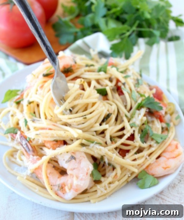Creamy One Pot Tuscan Shrimp Scampi Pasta 3 One Pot Tuscan Shrimp Scampi Pasta - Close-up of cooked pasta with shrimp, tomatoes, and herbs.