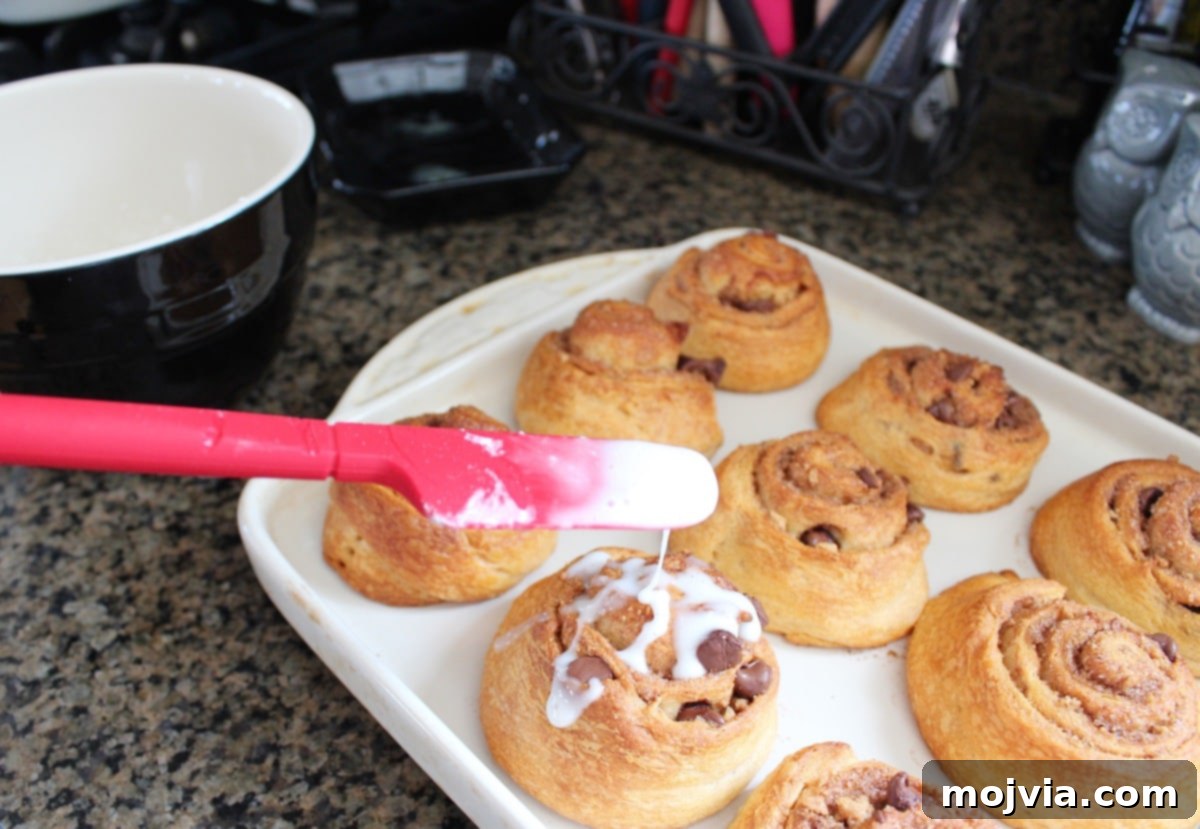 Baked S'Mores Cinnamon Rolls drizzled with sweet icing.