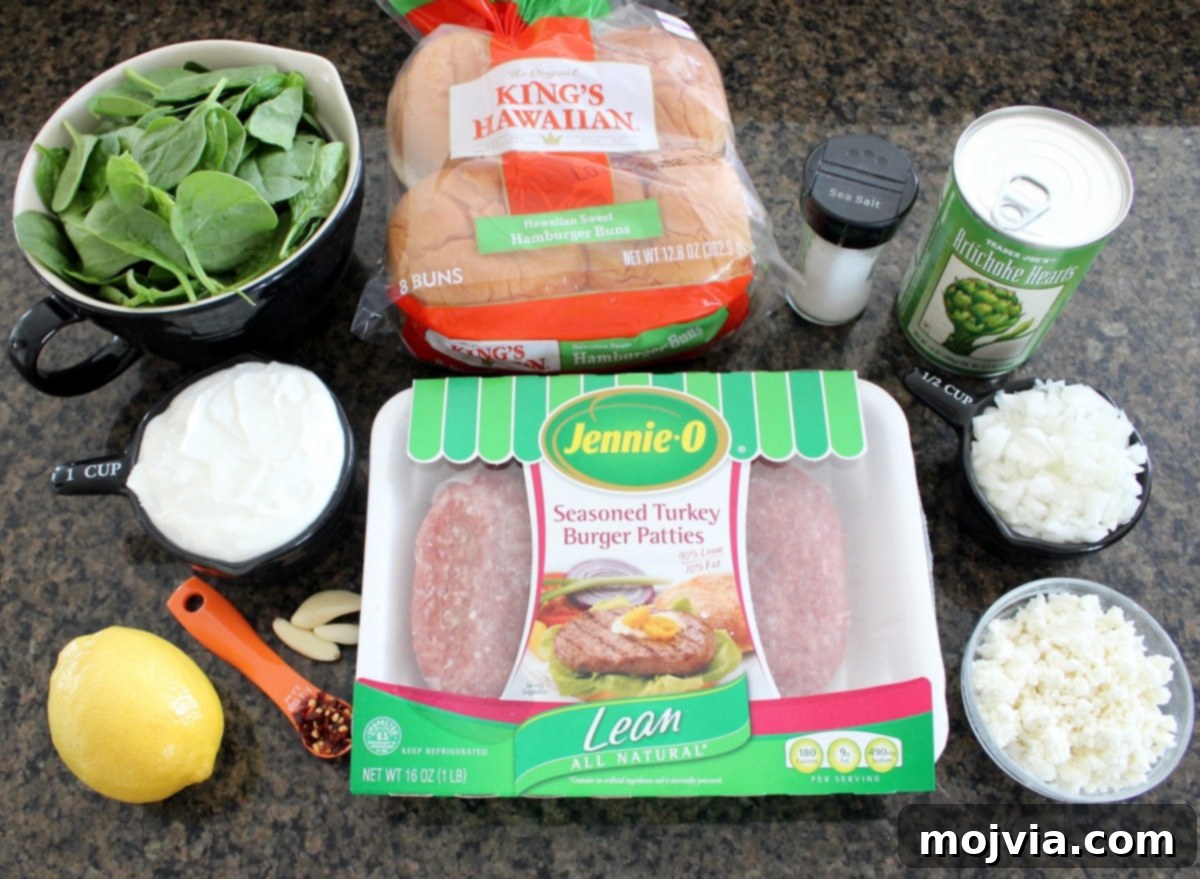 Gourmet Spinach Artichoke Turkey Burgers 3 Two Spinach Artichoke Turkey Burgers on a wooden board, garnished with fresh herbs and sun-dried tomatoes