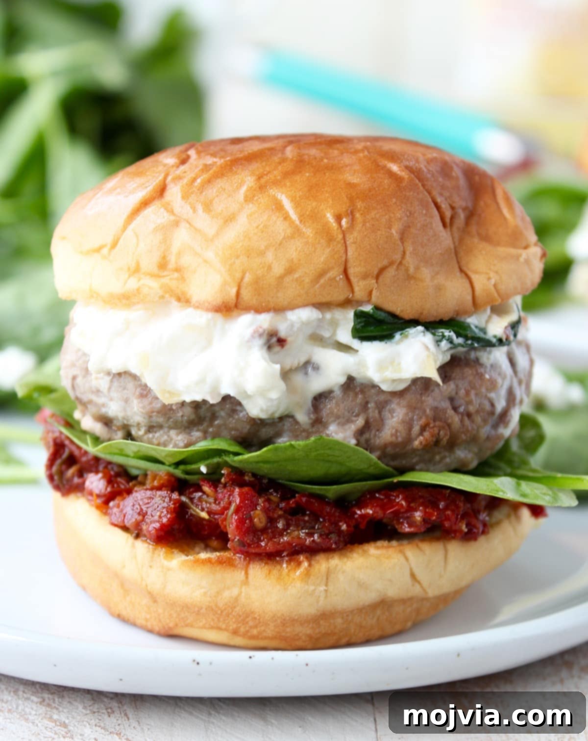 Gourmet Spinach Artichoke Turkey Burgers 8 A freshly assembled Spinach Artichoke Turkey Burger ready to be eaten