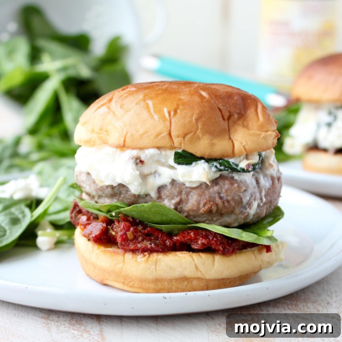 Gourmet Spinach Artichoke Turkey Burgers 9 A serving of Spinach Artichoke Dip Turkey Burgers with a side salad