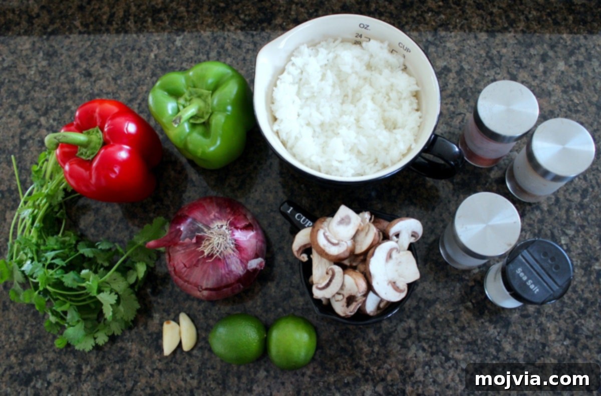 Vibrant Veggie Fajita Rice Bowl 3 Ingredients for Veggie Fajita Bowl arranged on a dark marble countertop