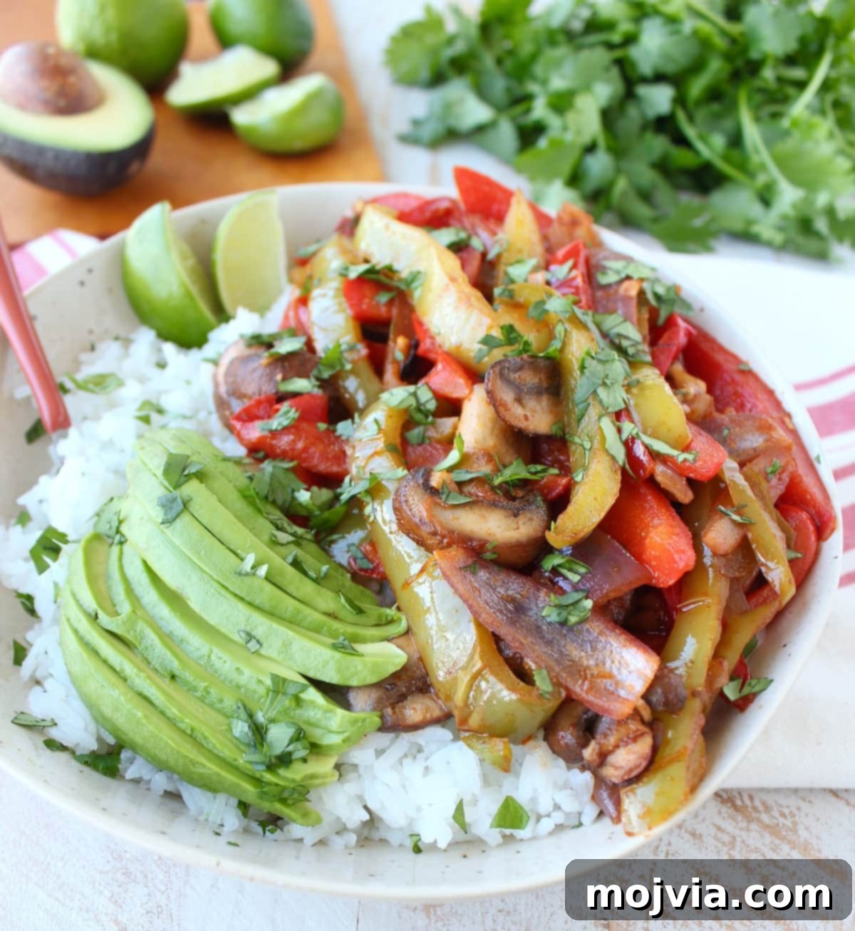 Vibrant Veggie Fajita Rice Bowl 5 Close-up of a Veggie Fajita Rice Bowl showing vibrant vegetables and avocado slices