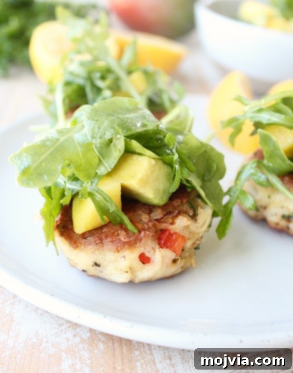 Tropical Coconut Crab Cakes with Zesty Mango Arugula Salad 2 Coconut Crab Cakes with Mango Arugula Salad on a serving platter