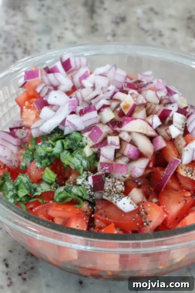 diced tomatoes, onions and basil in a glass bowl