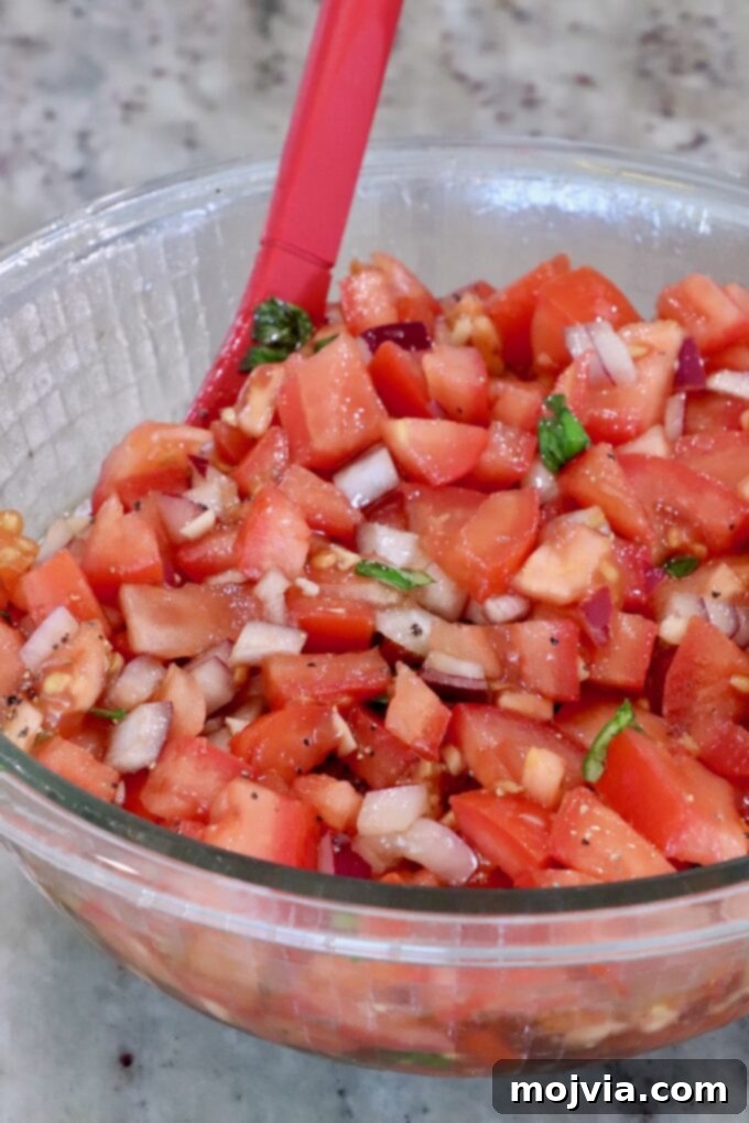 tomato bruschetta mixed together in a glass bowl