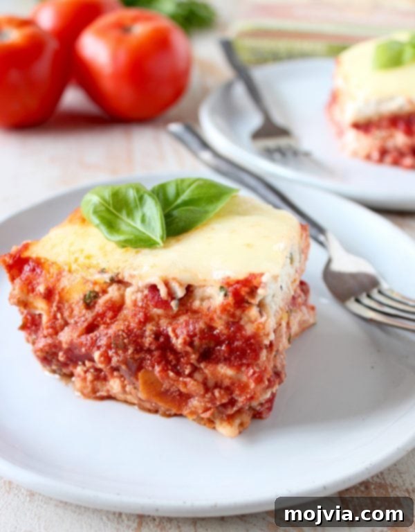 A perfectly plated slice of warm Garlic Naan Lasagna, showcasing its delightful layers