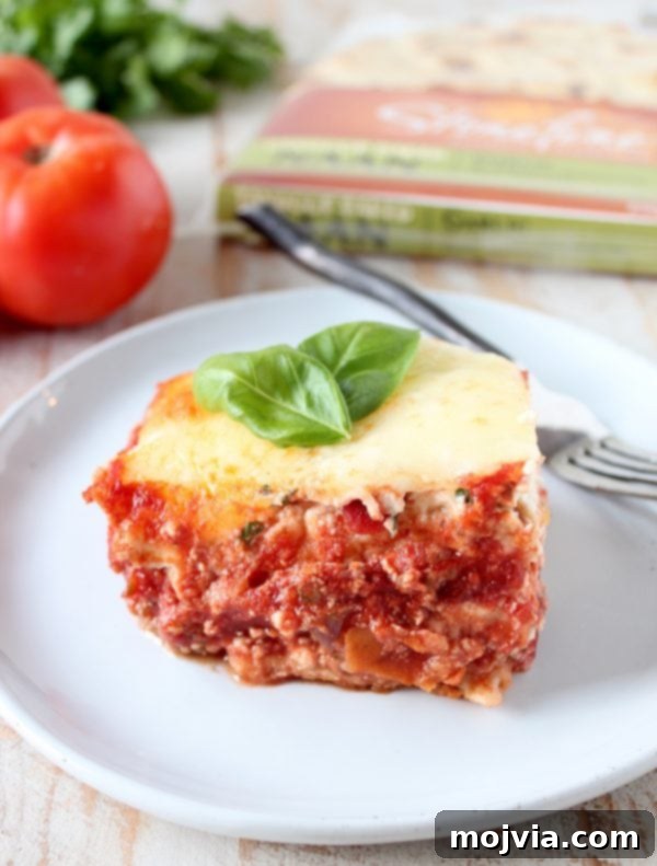 Layers of creamy ricotta, rich marinara, and soft garlic naan arranged in a baking dish
