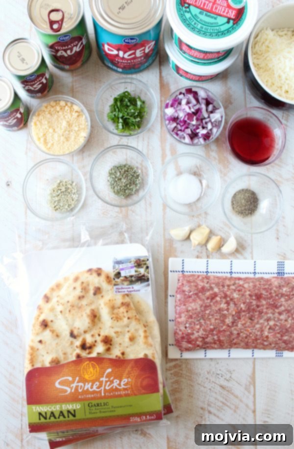Fresh ingredients for Naan Lasagna displayed, including naan bread, cheeses, and marinara components
