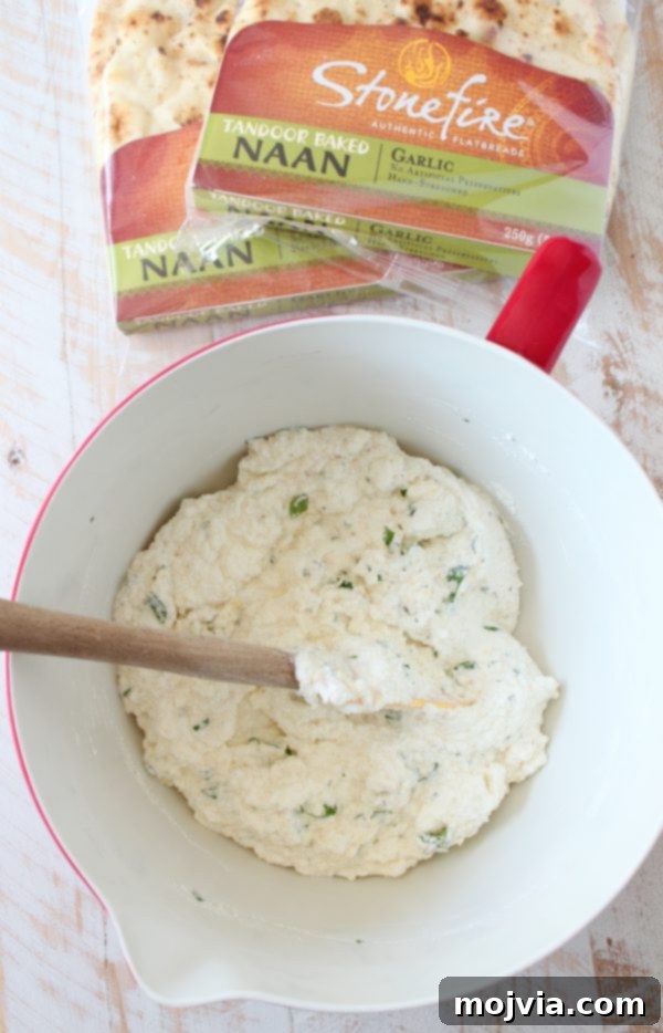 Mixing the creamy ricotta and fresh herb cheese mixture in a bowl for the lasagna