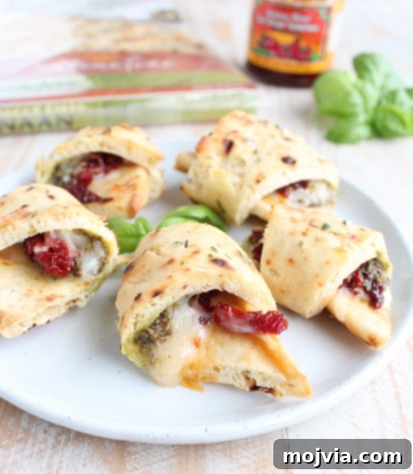 Easy Naan Pizza Rolls 2 Naan Pizza Rolls on a baking tray, a quick and delicious recipe.