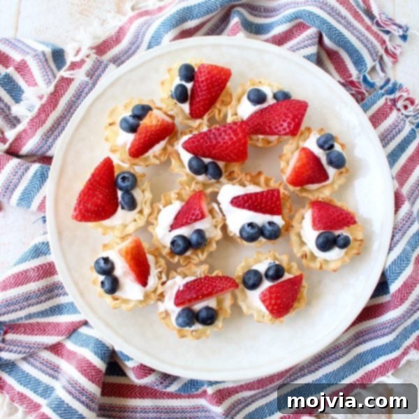 A tray of beautifully arranged Berry Cream Fillo Baskets, showcasing their perfect bite-sized form for any party.
