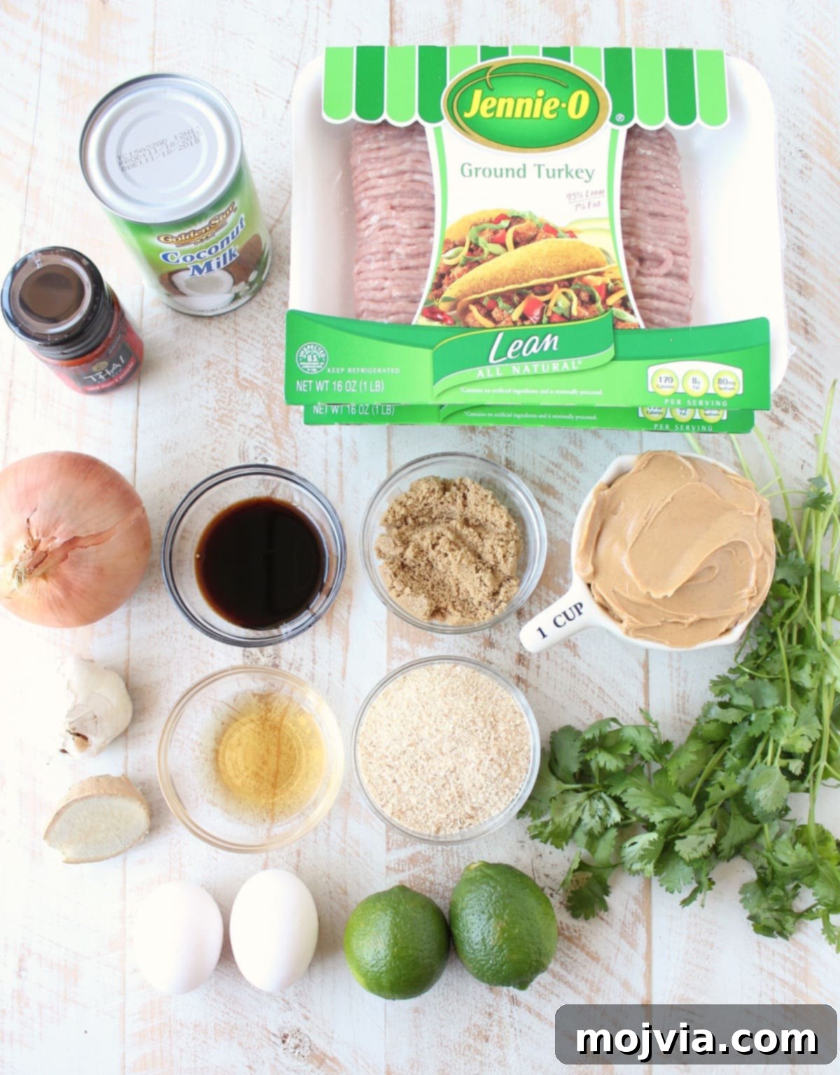 Thai Peanut Turkey Meatball Bliss 3 Ingredients for Thai Turkey Meatballs laid out on a white wooden board