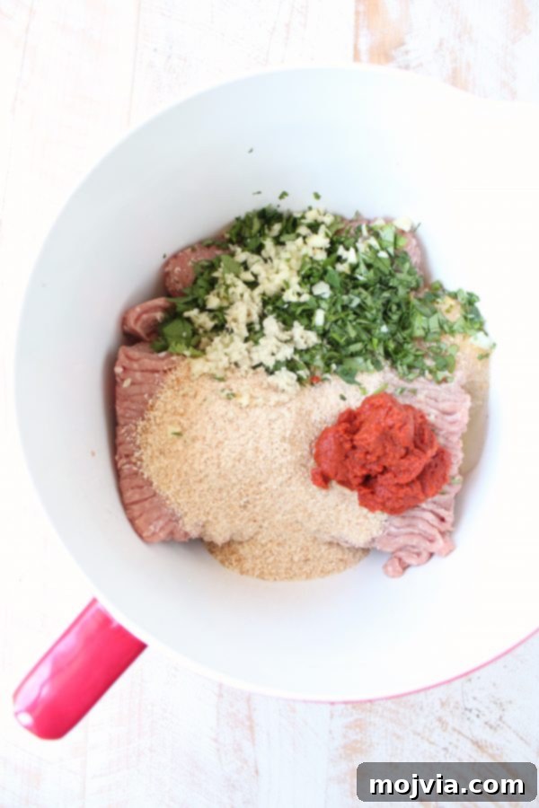 Thai Peanut Turkey Meatball Bliss 4 Ground turkey mixed with herbs, red curry paste, and breadcrumbs in a large mixing bowl