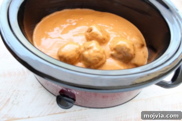 Thai Peanut Turkey Meatball Bliss 7 Turkey meatballs fully covered in peanut sauce inside a slow cooker