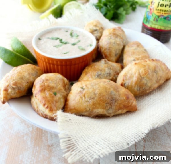 Fiery Jamaican Jerk Beef Patties 2 Golden-brown Jamaican Jerk Beef Patties arranged on a serving tray, ready for a party.