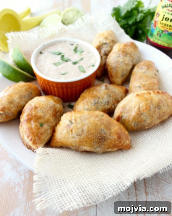 Fiery Jamaican Jerk Beef Patties 10 A plate of perfectly baked Jamaican Jerk Beef Patties, served with a side of creamy coconut jerk dipping sauce.