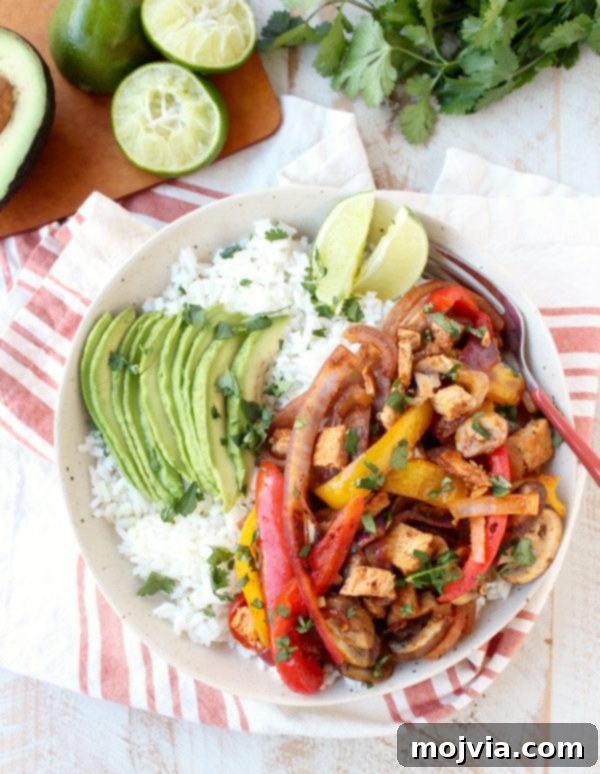 Sizzling Turkey Fajita Rice Bowl 2 Delicious Turkey Fajita Rice Bowl with colorful bell peppers, onions, and avocado