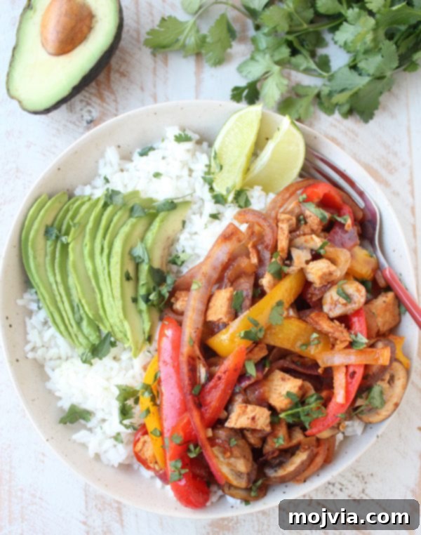 Sizzling Turkey Fajita Rice Bowl 4 Overhead view of a prepared Turkey Fajita Rice Bowl with sliced avocado