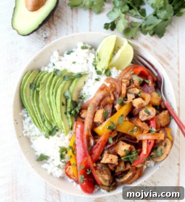 Sizzling Turkey Fajita Rice Bowl 6 A vibrant and colorful Turkey Fajita Rice Bowl, garnished with fresh cilantro and avocado slices