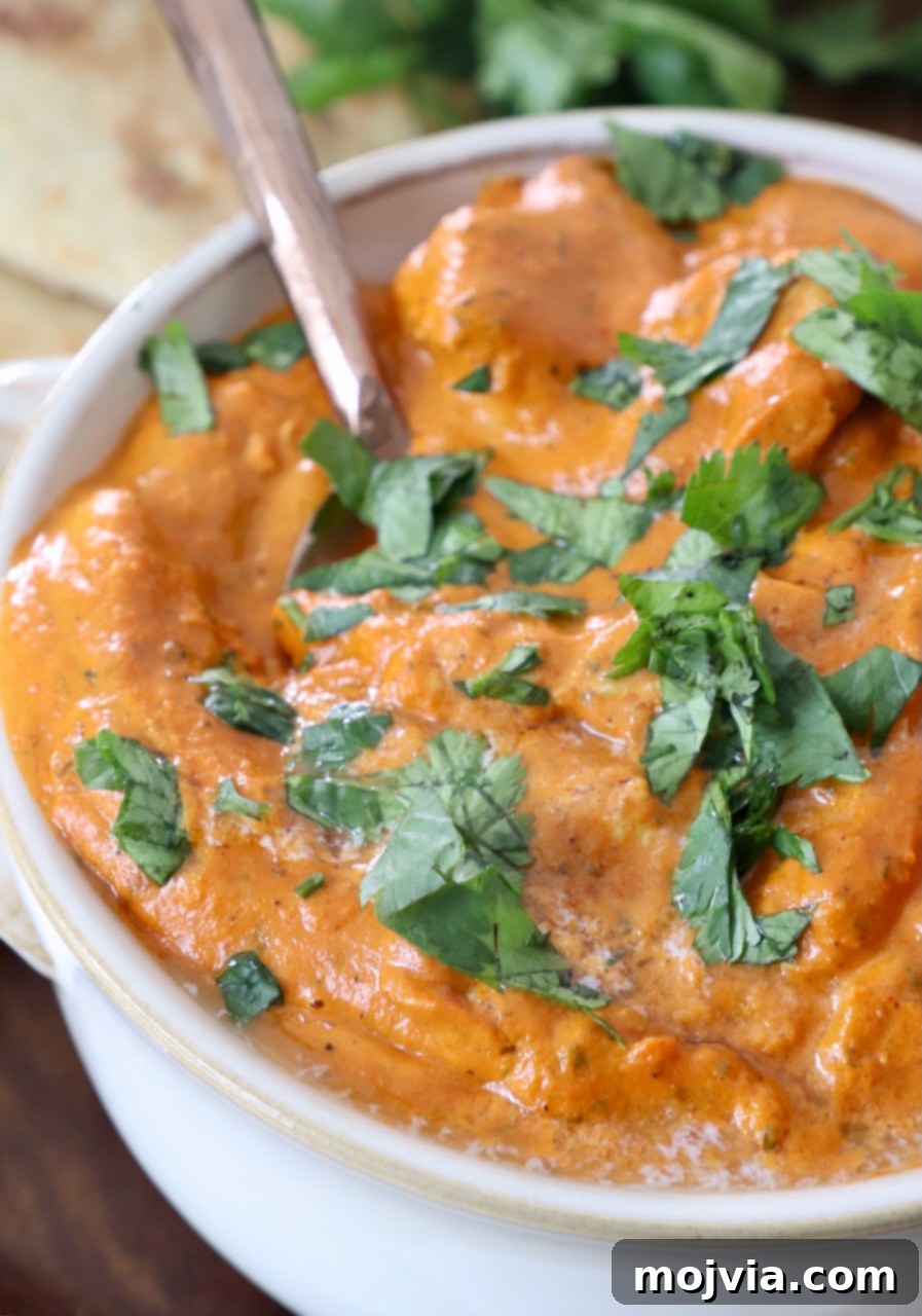 Velvet Butter Chicken 13 chicken makhani in white bowl with spoon