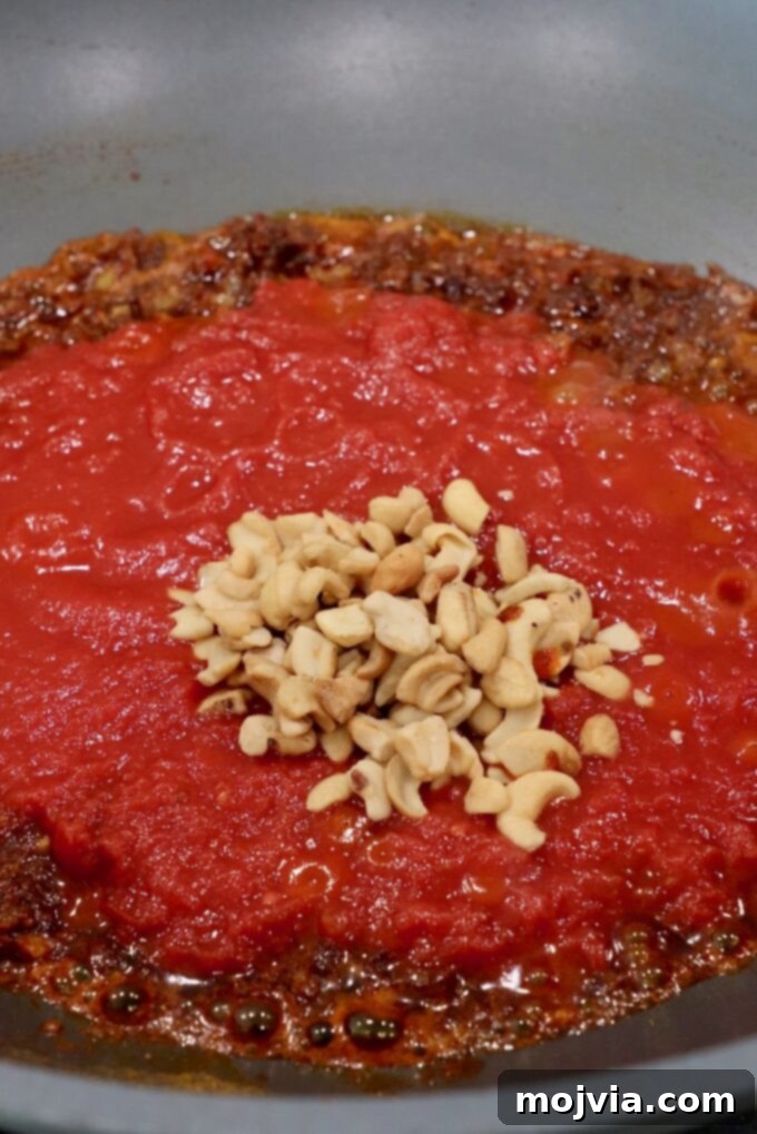 Velvet Butter Chicken 7 cashews and tomatoes with spices in large skillet