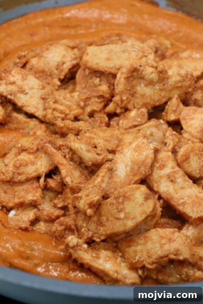 Velvet Butter Chicken 10 cooked sliced chicken in butter curry sauce in large skillet