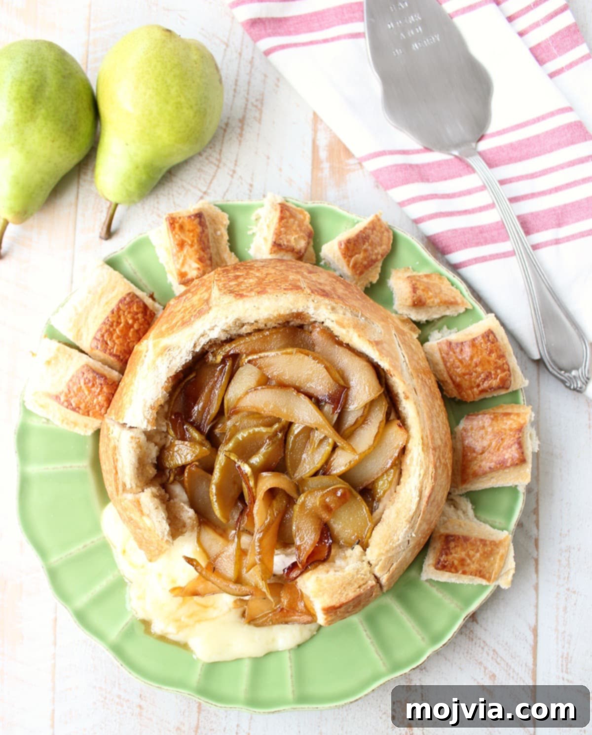 Decadent Caramelized Pear and Brie Bread Bowl 11 The golden-brown Baked Brie Bread Bowl with caramelized Bartlett pears, fresh from the oven and glistening with honey, a perfect holiday centerpiece.