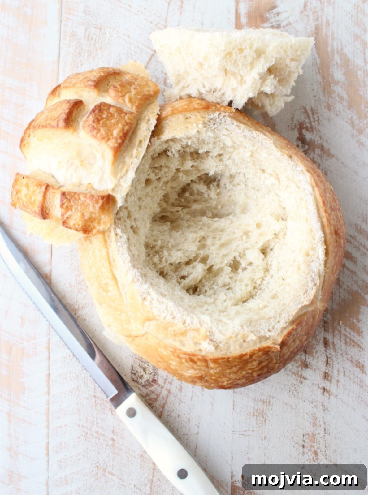 Decadent Caramelized Pear and Brie Bread Bowl 7 A hollowed-out sourdough bread round, perfectly prepared to cradle a wheel of baked brie.