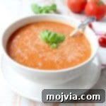 Roasted cherry tomatoes, garlic and onions are pureed into a vegan and gluten free tomato soup recipe, that's so easy to make in only 29 minutes!