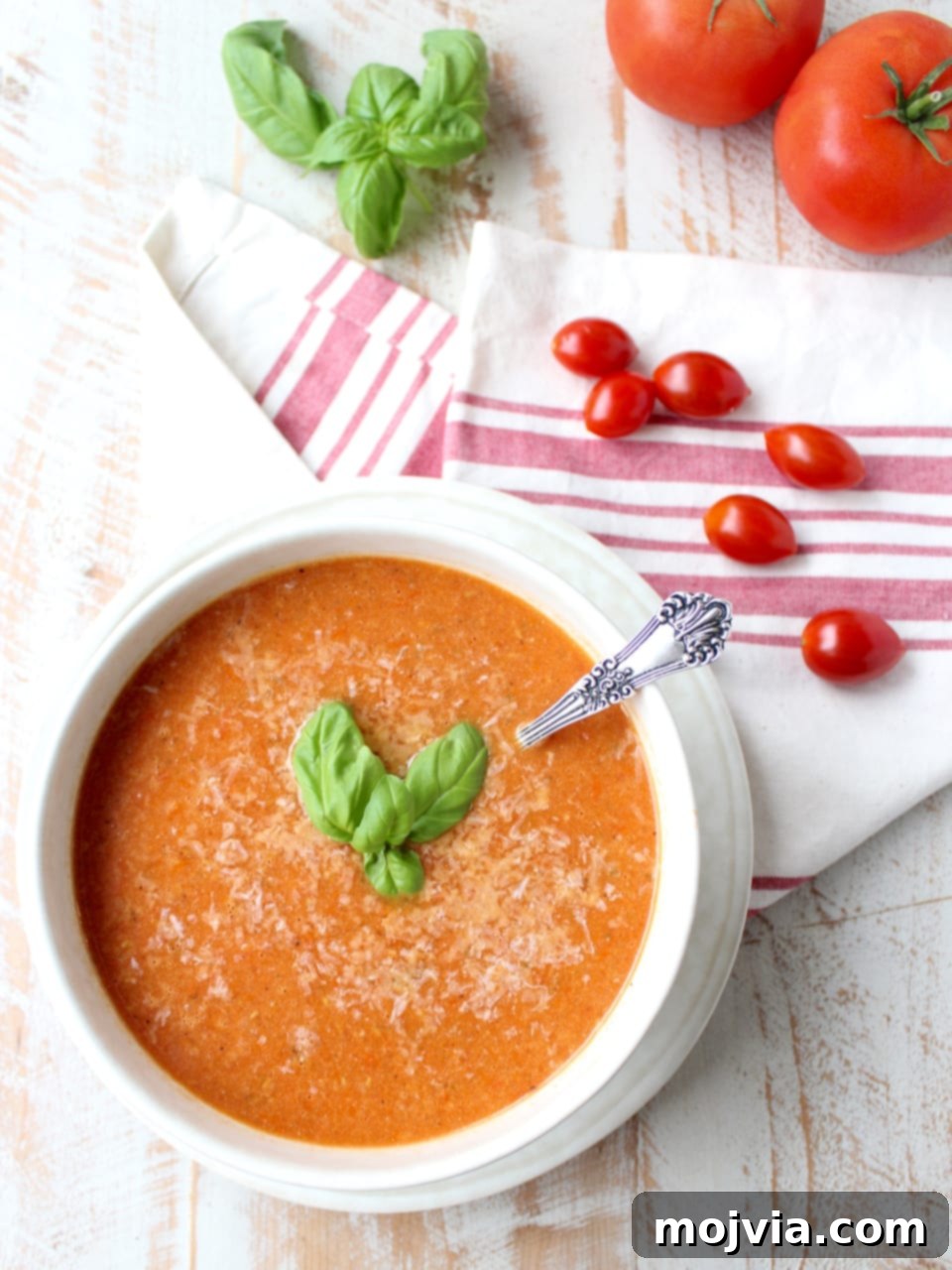 Fire-Kissed Tomato Bisque 8 tomato soup in bowl topped with basil leaves