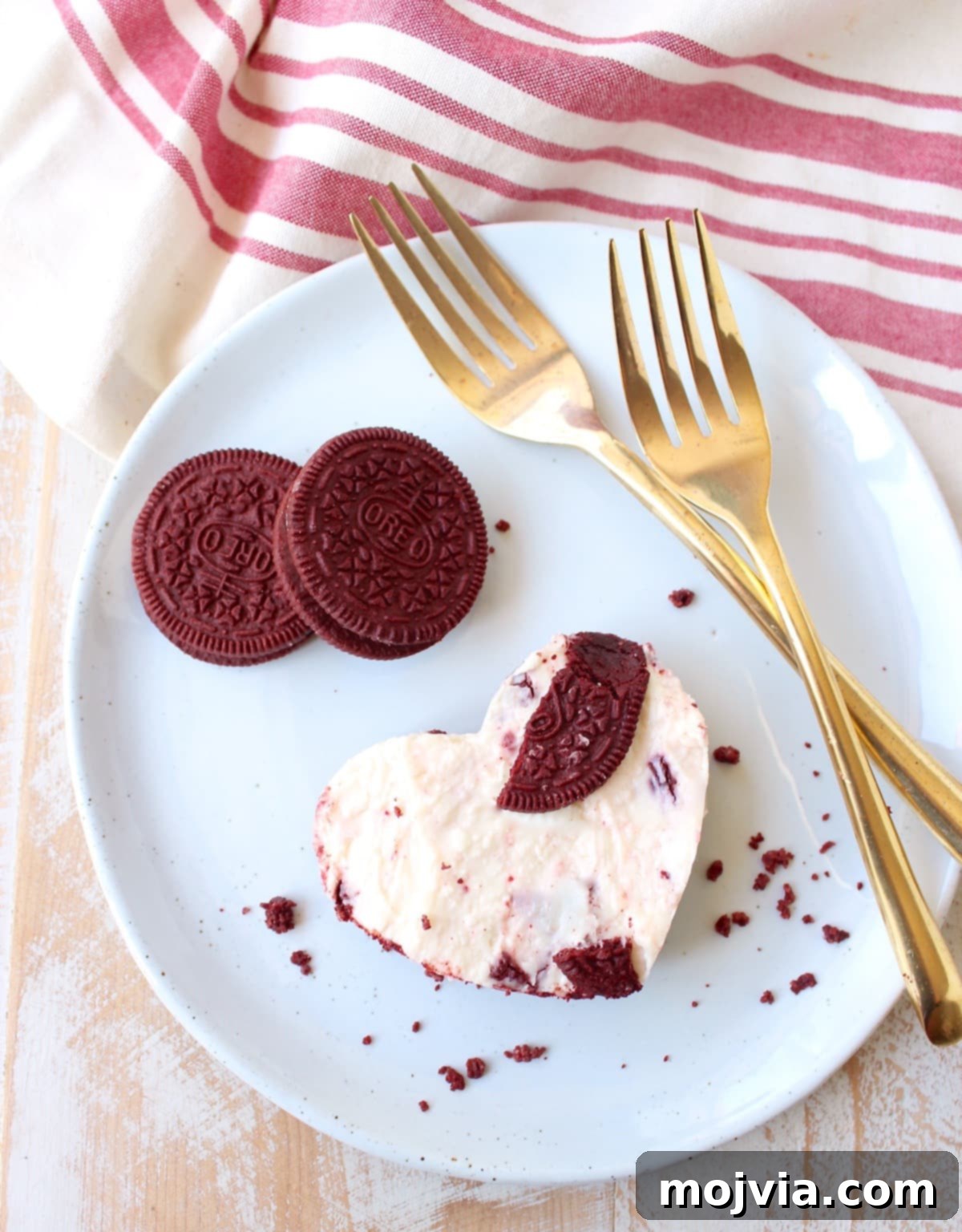 A large heart-shaped Red Velvet Oreo cheesecake bar, prominently displayed for serving as a main dessert.