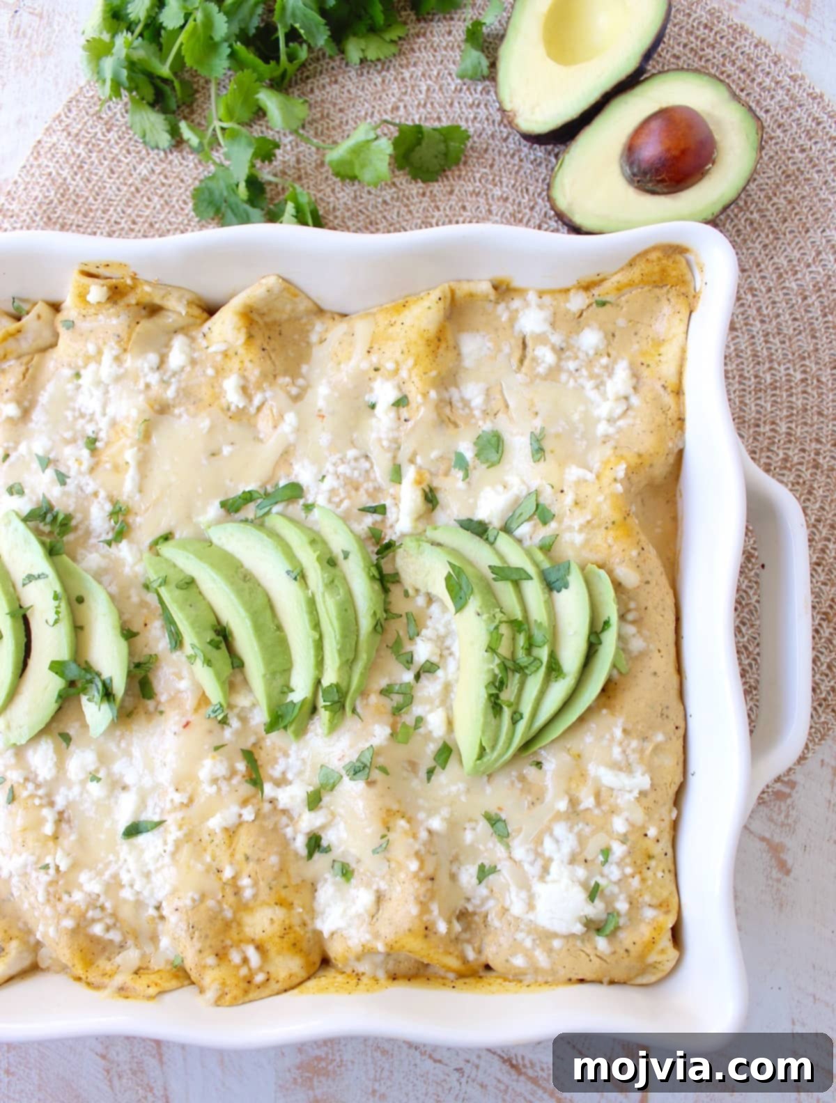 The best vegetarian enchiladas ever combine two cheeses, corn & deliciously creamy avocado sauce for a mouth watering meatless Mexican recipe!