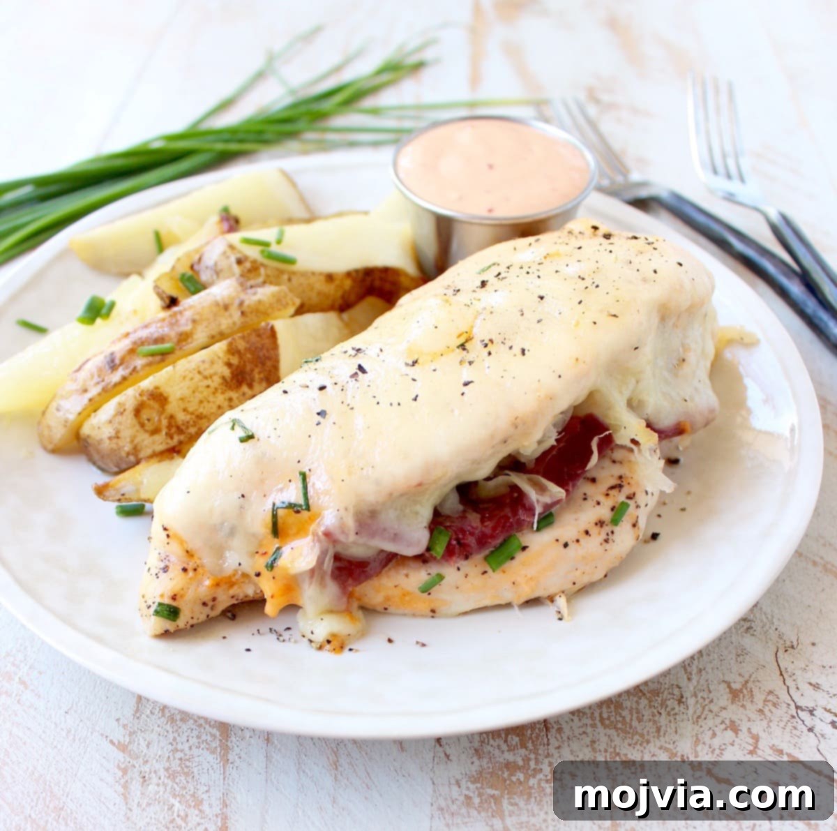 Reuben Chicken Roulade 4 Reuben Stuffed Chicken served with a side of roasted potatoes.