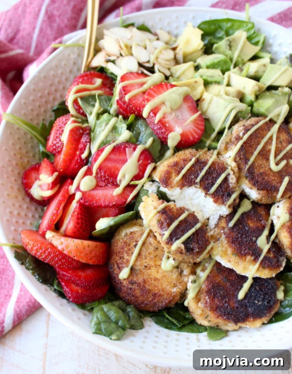 Goat Cheese Crisp, Strawberry and Avocado Salad 2 Crispy goat cheese, creamy avocado & juicy strawberries top spinach & arugula, tossed with avocado vinaigrette, for the perfect vegetarian Spring salad!