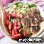 Crispy goat cheese, creamy avocado & juicy strawberries top spinach & arugula, tossed with avocado vinaigrette, for the perfect vegetarian Spring salad!