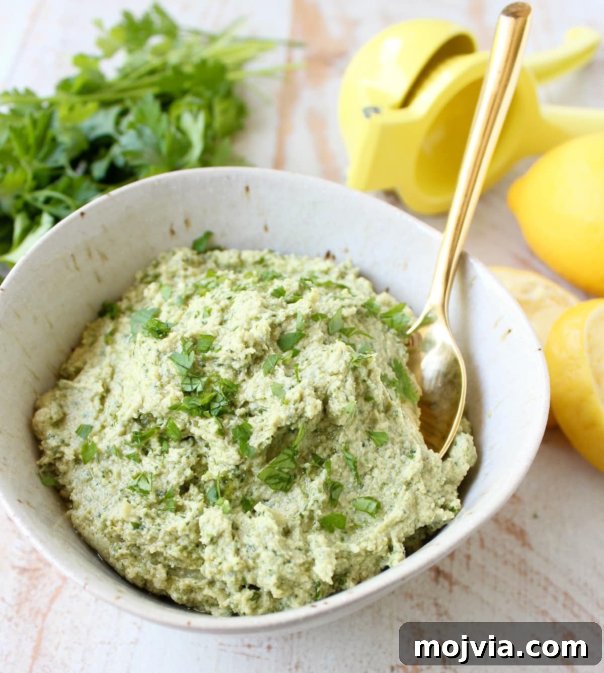 This healthy, vegan and gluten free Green Tahini Sauce Recipe is perfect for topping buddha bowls, chicken and fish, or serve it as a dip with veggies!