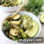 Vibrant Grilled Vegan Buddha Bowl 2 The Green Vegan Buddha Bowl is filled with grilled veggies, green tahini sauce, avocado & quinoa for a healthy, filling meal that's also gluten free!