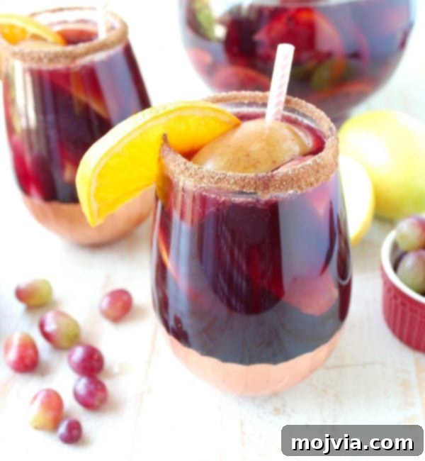 Ember-Kissed Fruit Sangria 11 Red Wine Sangria is given a delicious twist in this refreshing cocktail recipe that features cinnamon sugar grilled peaches, apples, oranges and lemons!