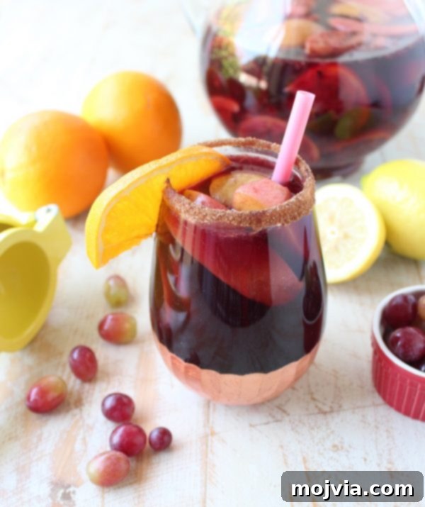 Ember-Kissed Fruit Sangria 12 Red Wine Sangria is given a delicious twist in this refreshing cocktail recipe that features cinnamon sugar grilled peaches, apples, oranges and lemons!