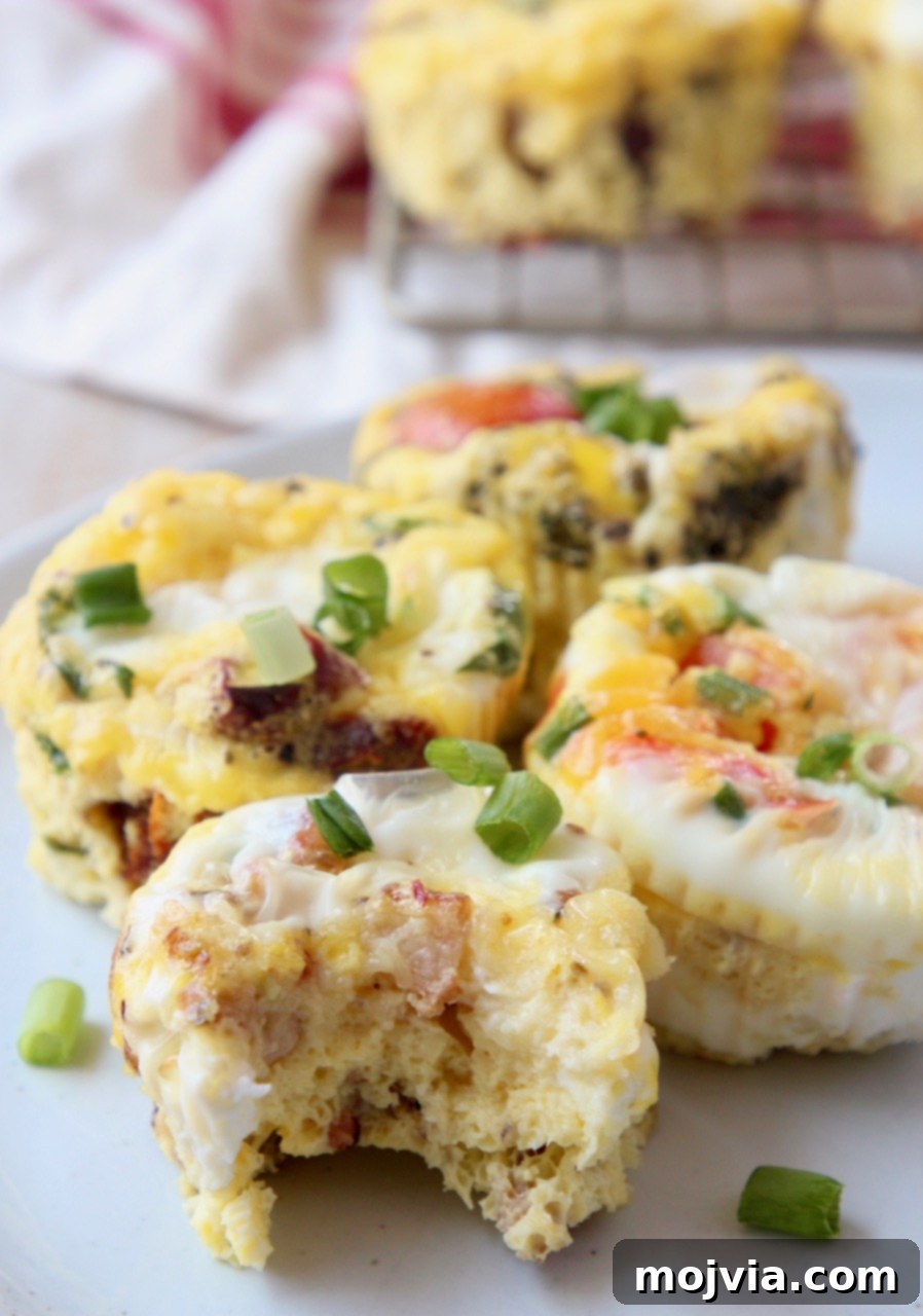 A keto egg muffin with zero net carbs, having a bite taken out, showcasing its delicious texture and fillings