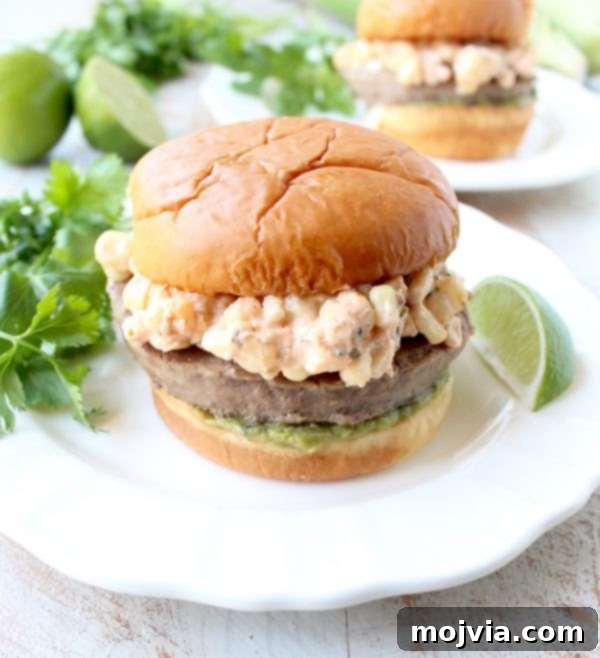 Zesty Elote Turkey Burgers 2 Mexican turkey burgers are covered in cotija cheese, guacamole and grilled Mexican street corn for a flavorful summer burger recipe!
