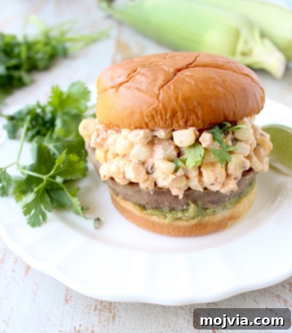Zesty Elote Turkey Burgers 3 Mexican turkey burgers are covered in cotija cheese, guacamole and grilled Mexican street corn for a flavorful summer burger recipe!