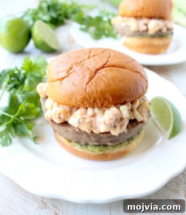 Zesty Elote Turkey Burgers 4 Mexican turkey burgers are covered in cotija cheese, guacamole and grilled Mexican street corn for a flavorful summer burger recipe!