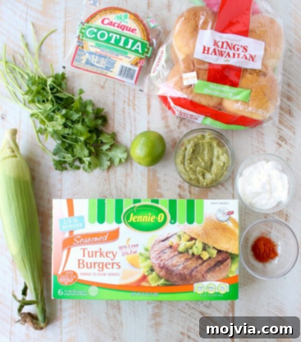 Zesty Elote Turkey Burgers 5 Mexican turkey burgers are covered in cotija cheese, guacamole and grilled Mexican street corn for a flavorful summer burger recipe!